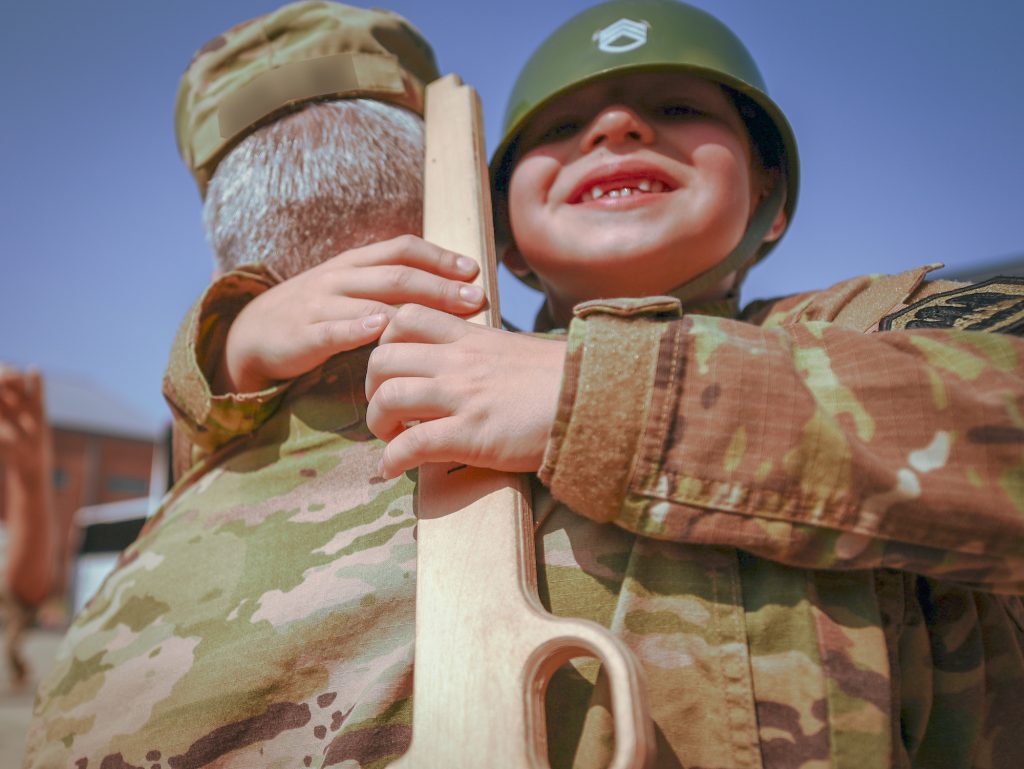 Son hugs his recently-deployed dad for the first time in nine months