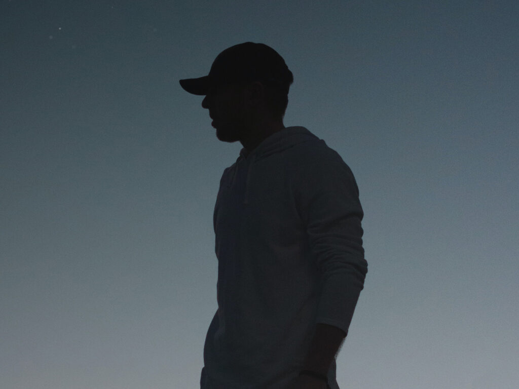 silhouette side profile of a man in a baseball cap