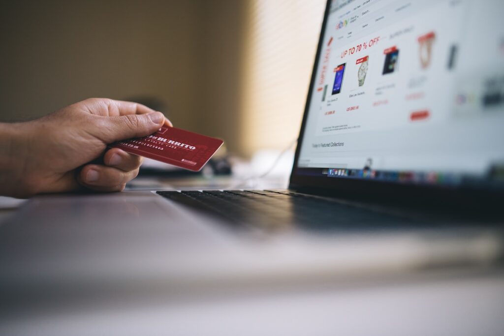 person holding a credit card, browses an online list of first responder discounts