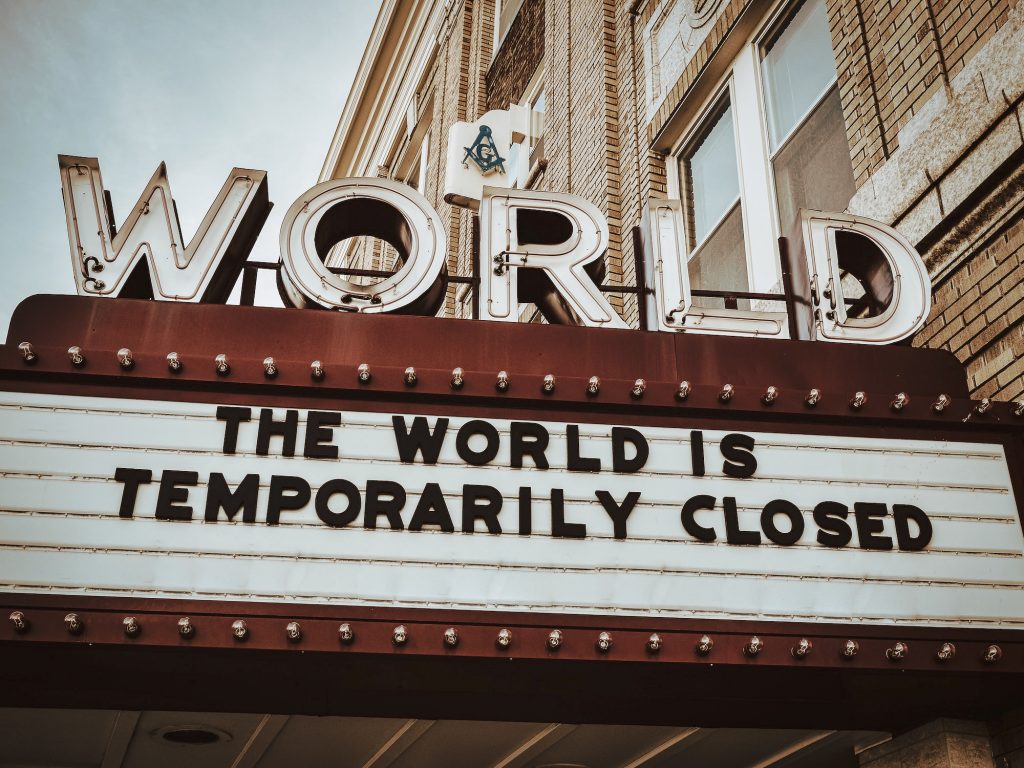 marquee sign at world theater reading "the world is temporarily closed"