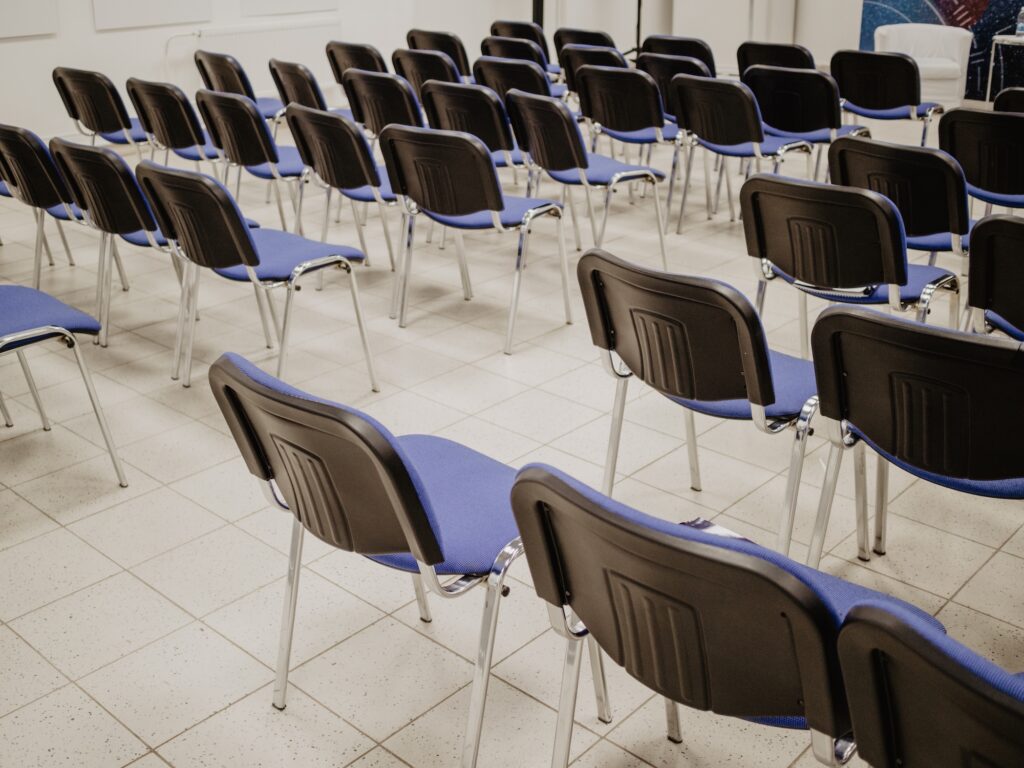 empty chairs lined up in a meeting hall