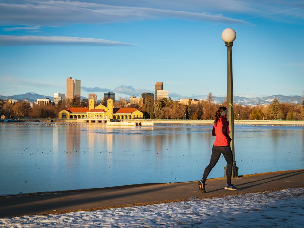 An athlete runs around City Park in Denver, CO